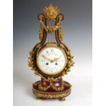 A late 19th century French mahogany and gilt metal mounted Empire style mantle clock, the slightly