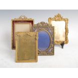 Four assorted early 20th century gilt metal photograph frames, one cast in the Rococo style with