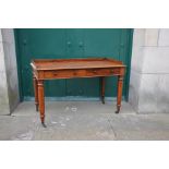 A Victorian mahogany writing table, the rectangular top with moulded edge an three quarter