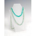 Two jade single strand graduated bead necklaces, one strand of rich green colour, 43.5cm long, the