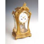 A late 19th century French Rococo style mantle clock, the circular porcelain dial with blue