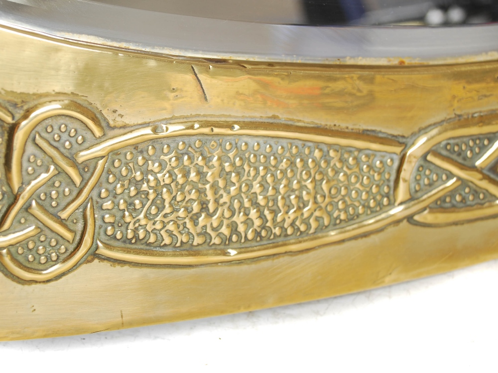 A Scottish Arts & Crafts brass wall mirror, the oval bevelled mirror plate within an embossed Celtic - Image 4 of 10