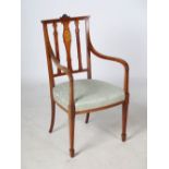 An Edwardian mahogany and marquetry inlaid armchair, the back inlaid with an oval panel of cherub