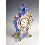 A late 19th century French porcelain blue ground mantle clock in the Rococo style, the slightly