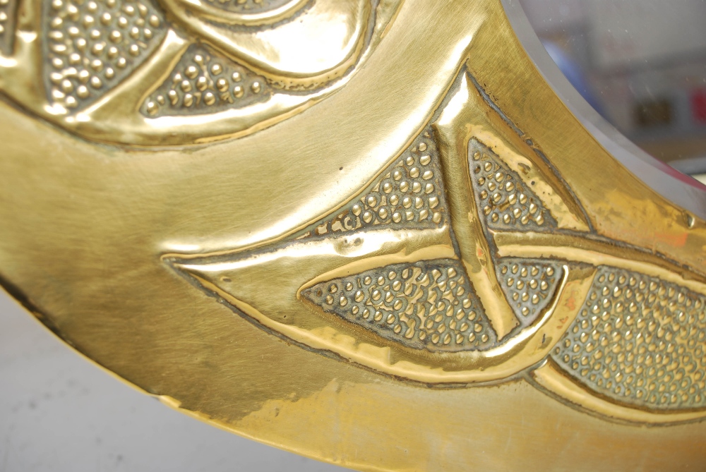 A Scottish Arts & Crafts brass wall mirror, the oval bevelled mirror plate within an embossed Celtic - Image 3 of 10
