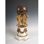 An Empire style bronze, white marble and ormolu mounted ball clock, the spherical ball with Roman