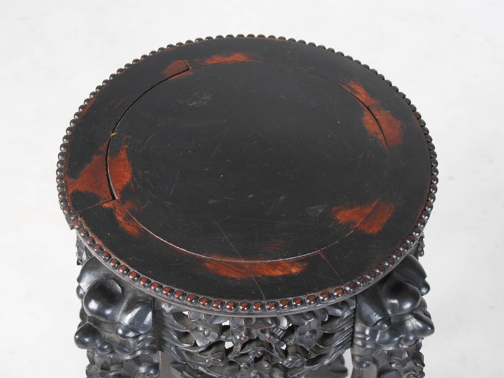 A Chinese dark wood jardiniere stand, Qing Dynasty, the circular panelled top above a pierced and - Image 2 of 5