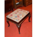 A Victorian rosewood rectangular stool, the drop in needlework upholstered top set into a mahogany