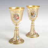 A pair of late 19th century Bohemian clear and opaque white overlaid glass goblets, decorated with