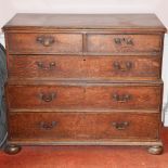 A George III oak two part chest, the rectangular top with a moulded edge above two short and one
