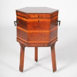 A 19th century mahogany and rosewood banded hexagonal shaped cellarette, the hinged top opening to a