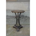 A Victorian cast iron occasional table, the circular top raised on three foliate cast concave