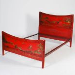 An early 20th century red lacquer Chinoiserie decorated double bed, with concave head and foot