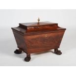 A 19th century mahogany sarcophagus shaped wine cooler, the hinged cover centred with a brass urn