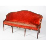 A late 19th/ early 20th century mahogany sofa in the George III style, with red velvet upholstered