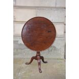 A George III mahogany birdcage snap top tripod table, the slightly dished circular top with a