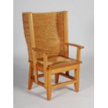 A 20th century pine Orkney chair, with woven back and drop in rush seat, raised on tapered square