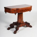 A Victorian mahogany pedestal tea table, the shaped rectangular top raised on a tapered
