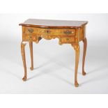 A 19th century Dutch walnut and marquetry inlaid low boy, the shaped rectangular top with a slightly
