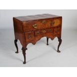 A George II walnut low boy, the rectangular top above a long frieze drawer and central shallow