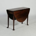 A George III laburnum drop leaf table, the oval top with twin drop leaves, raised on tapered