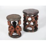 Two tribal carved wood stools, the larger with a circular top supported on pierced and carved
