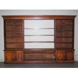 A Victorian oak bookcase, the moulded cornice above a central section of three adjustable shelves