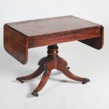 A 19th century mahogany sofa table, the rectangular top with twin drop leaves and two blind frieze