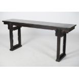 A Chinese dark wood altar table, Qing Dynasty, the rectangular panelled top above a plain frieze