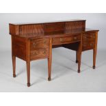 A George III mahogany serpentine sideboard, the stage back with two tambour slides above a central