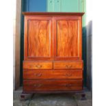 WITHDRAWN FROM SALE A 19th century George III style mahogany linen press, the moulded cornice and