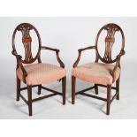 A pair of early 20th century George III style mahogany elbow chairs, the oval shaped backs with