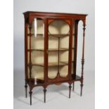 An Edwardian mahogany and satinwood banded display cabinet on stand, the moulded cornice above a