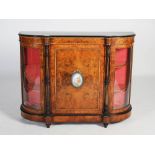 A Victorian walnut, porcelain and ormolu mounted credenza, the shaped rectangular top above a single