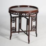 A Chinese dark wood circular folding table, late Qing Dynasty, the circular top with a raised edge