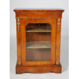 A Victorian walnut and ormolu mounted pier cabinet, the rectangular top above a single glazed