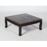 A Chinese dark wood Kang table, late 19th/ early 20th century, the square top raised on four