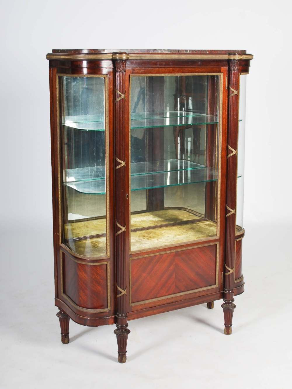 A late 19th century mahogany and gilt metal mounted display cabinet, the mottled red marble top