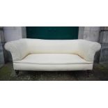 WITHDRAWN - A Victorian mahogany sofa, upholstered in white calico,