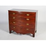 A George III mahogany and boxwood lined bow front chest, the shaped top above four long graduated