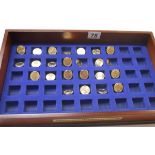 Selection of 24 presidential dollars in display case