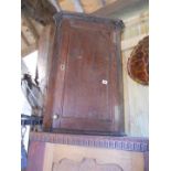 Early oak corner cupboard with shaped shelves