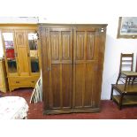 Linen-fold oak wardrobe