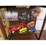 Collection of Lego over 2 shelves to include battery powered car, fire engine etc.