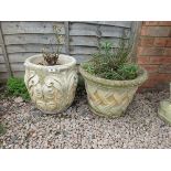 2 circular stone planters