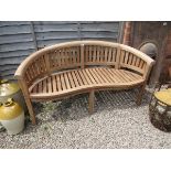 Brand new teak 'Banana' bench - Estimate £180 to £220