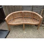 Brand new teak 'Banana' bench - Estimate £180 to £220