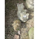 2 stone pig figures
