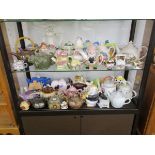 Large collection of novelty teapots over two shelves