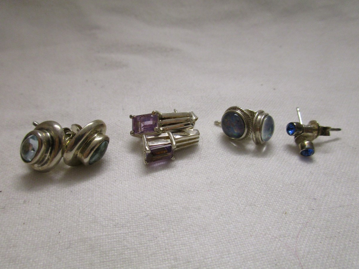 4 pairs of silver and stone set earrings